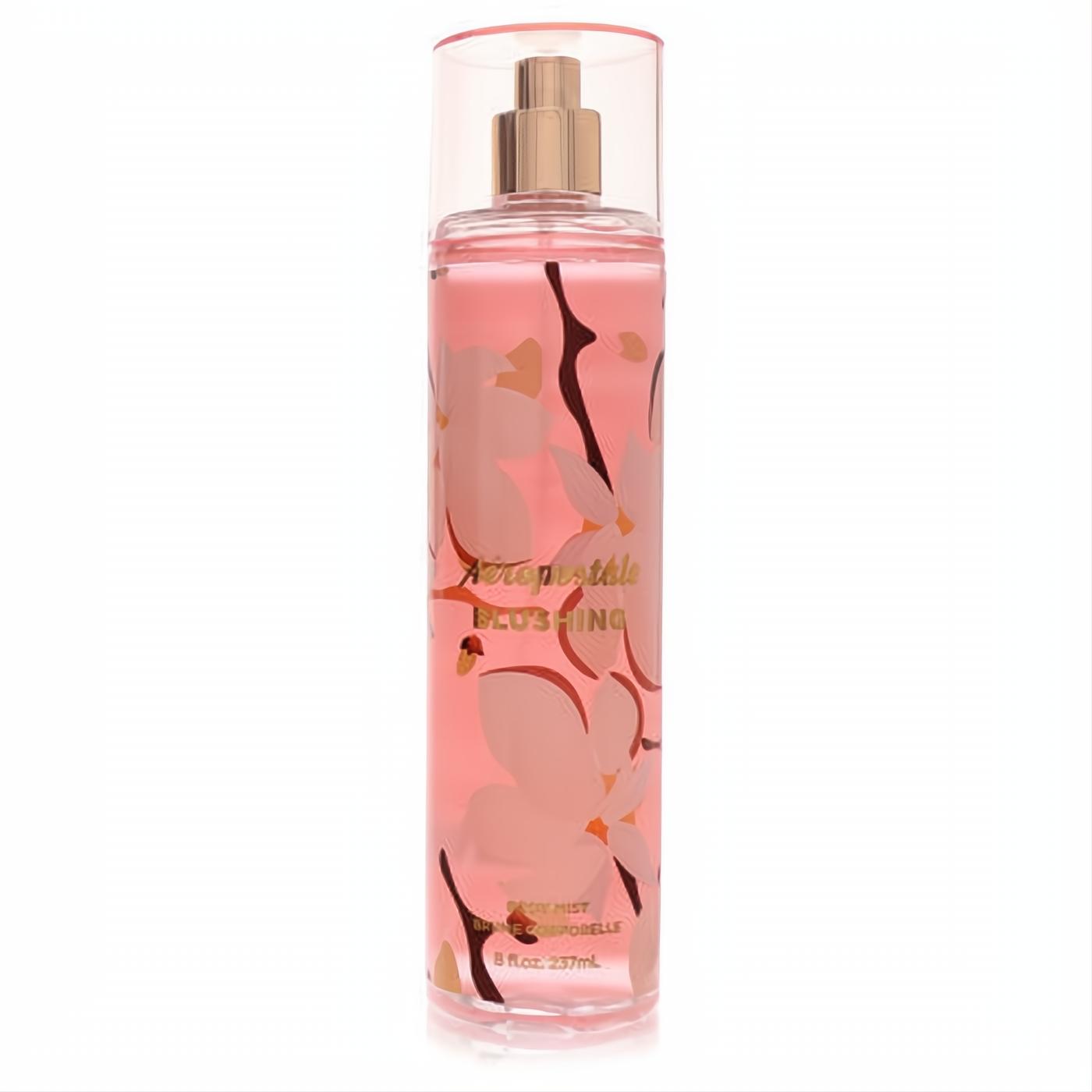 Aeropostale Blushing 8 oz body mist. Pink liquid in a clear bottle with a gold sprayer and elegant floral art.