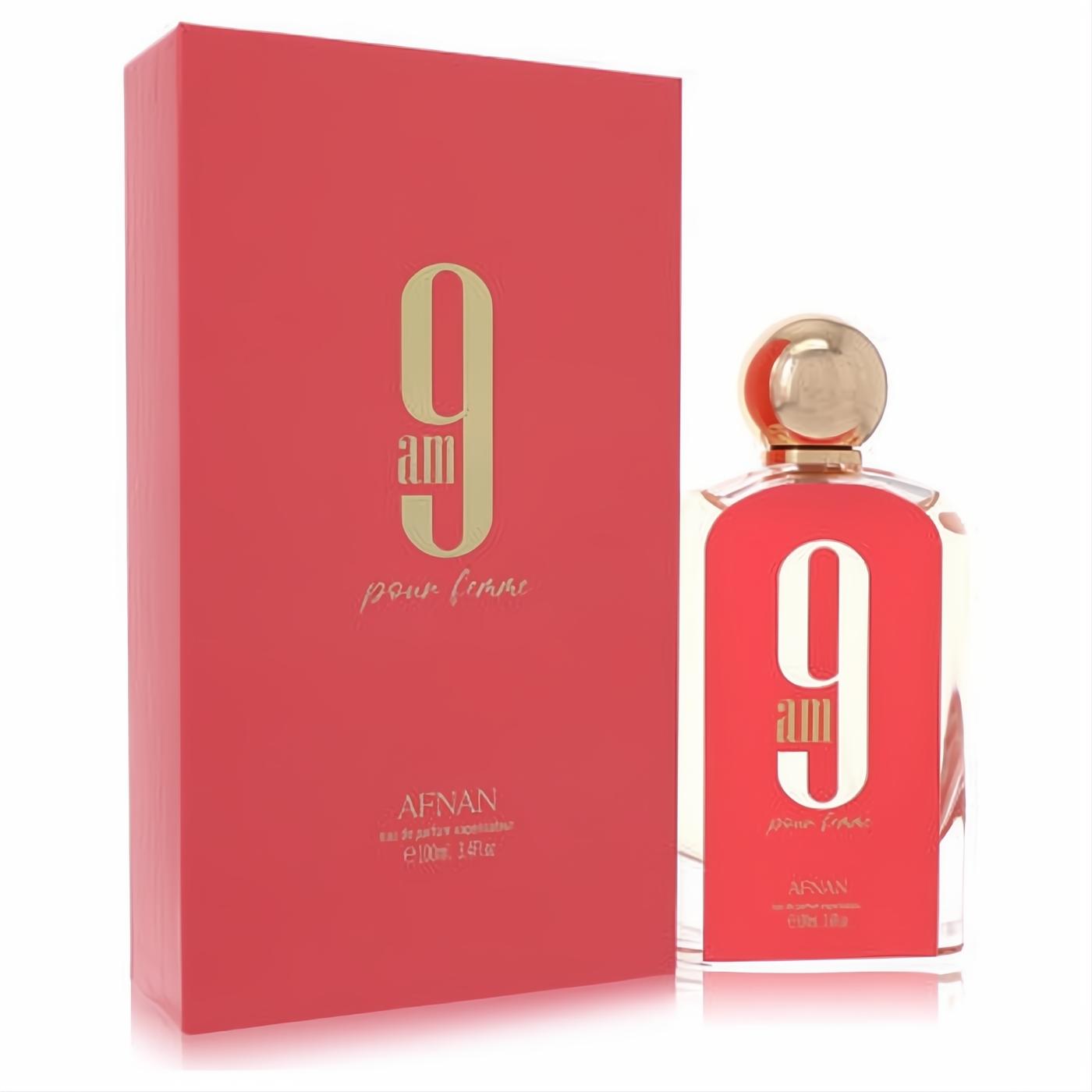 Afnan 9am Pour Femme 3.4 oz Eau De Parfum. Elegant coral-pink bottle with gold cap, '9 am' logo, and matching box.