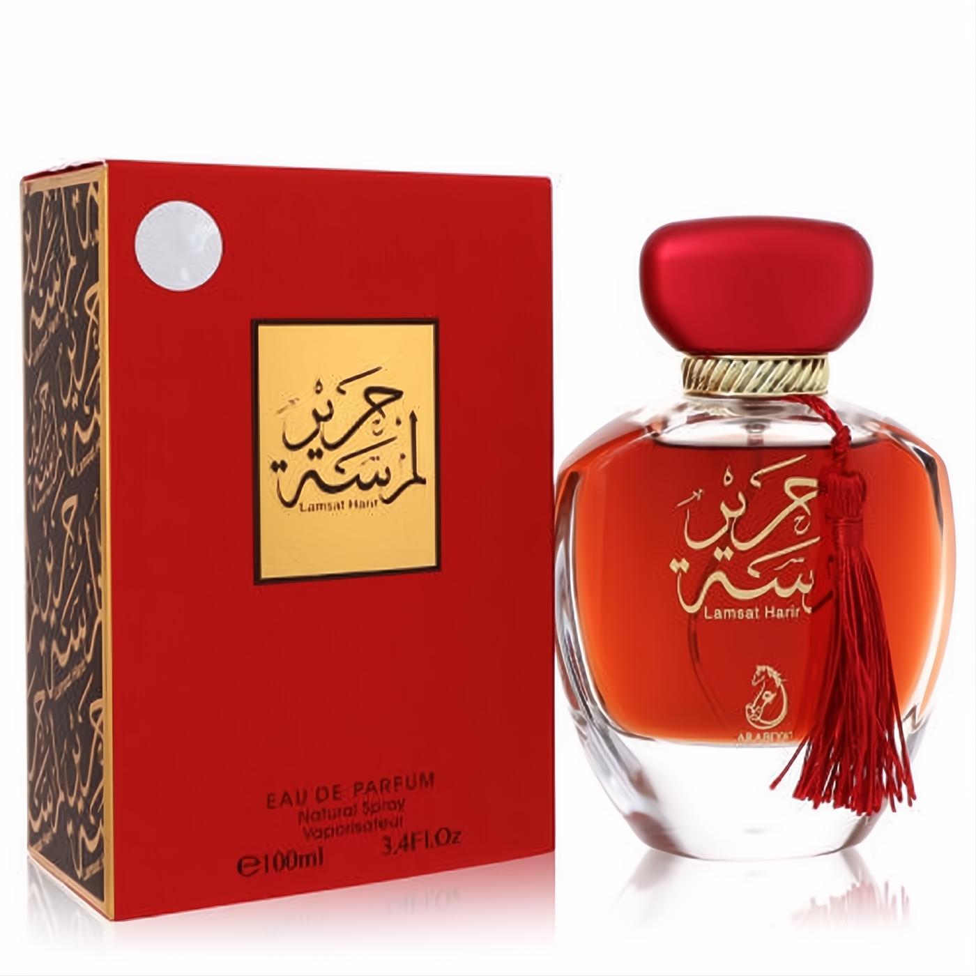 Exquisite Arabiyat Lamsat Harir 3.4 oz EDP. Luxurious red and gold bottle with tassel, matching box, and elegant Arabic script.