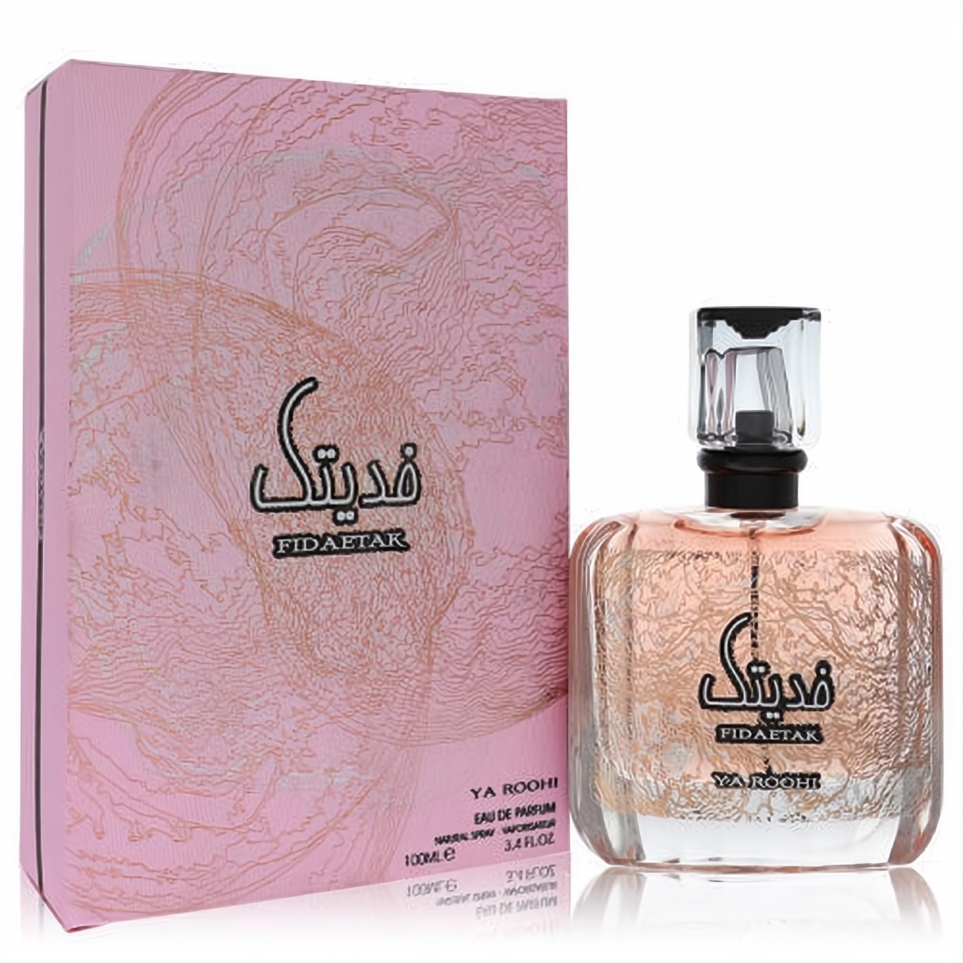 Ard Al Zaafaran Fidaetak Ya Roohi 3.4 oz EDP. Luxurious clear glass bottle with intricate rose gold texture and elegant pink box.