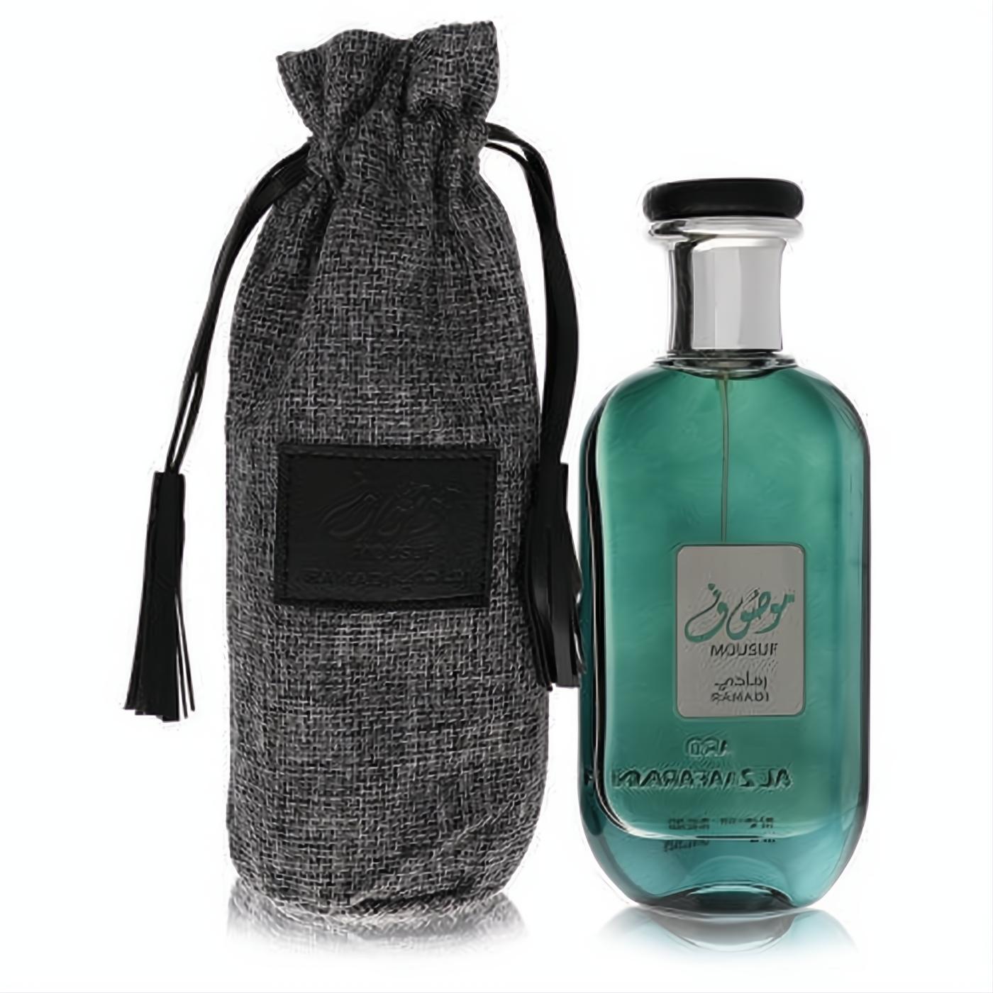 Elegant Ard Al Zaafaran Mousuf Ramadi 3.4 oz unisex perfume. Sleek teal glass bottle, silver cap, and a premium grey textured drawstring pouch.