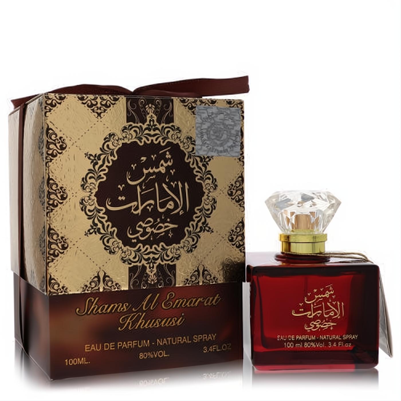 Ard Al Zaafaran Shams Al Emarat Khususi 3.4 oz unisex EDP. Elegant red bottle with diamond cap next to an ornate gold and brown gift box.