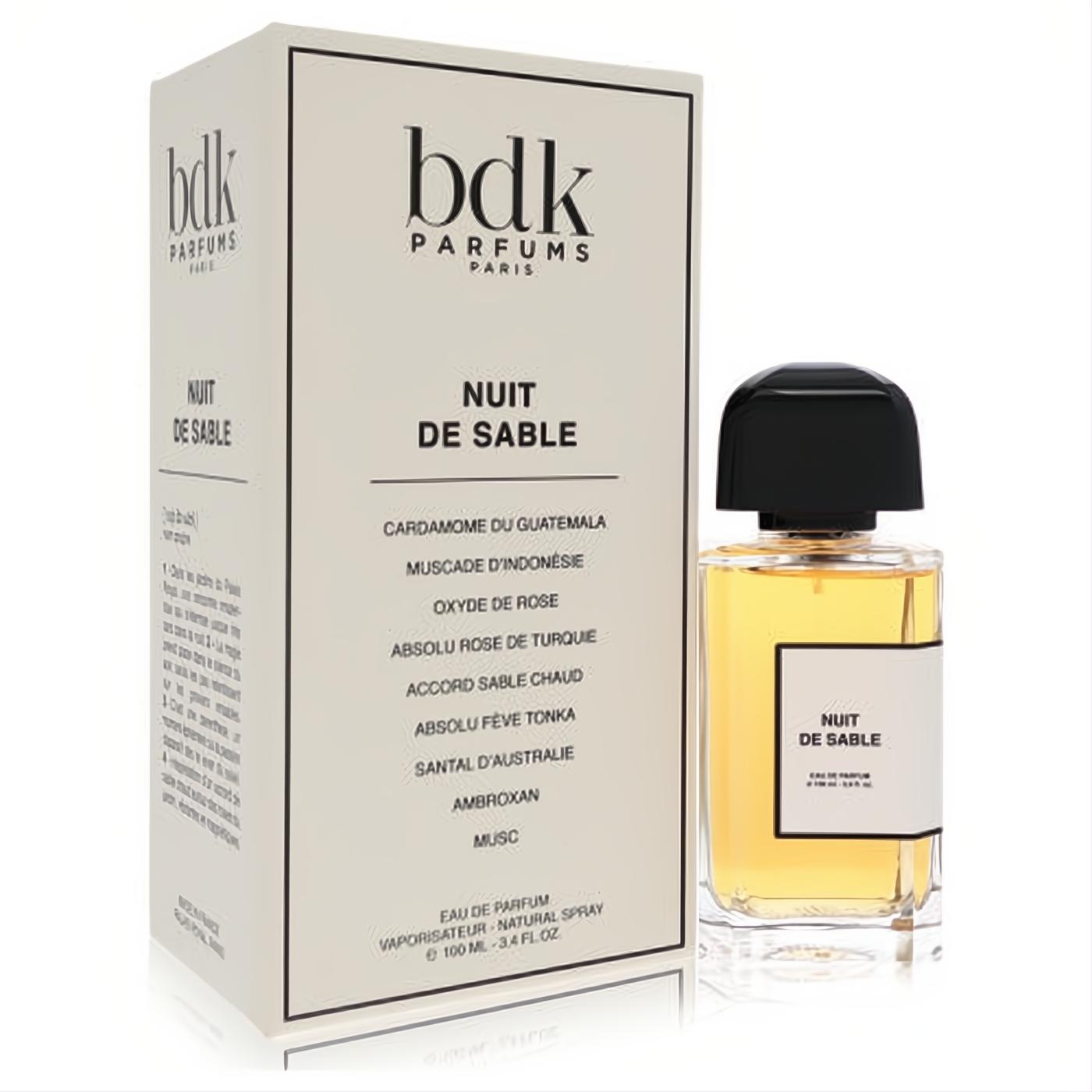 Experience Bdk Nuit De Sable unisex Eau De Parfum spray, 3.4 oz. Sleek clear bottle with golden fragrance and elegant white box.