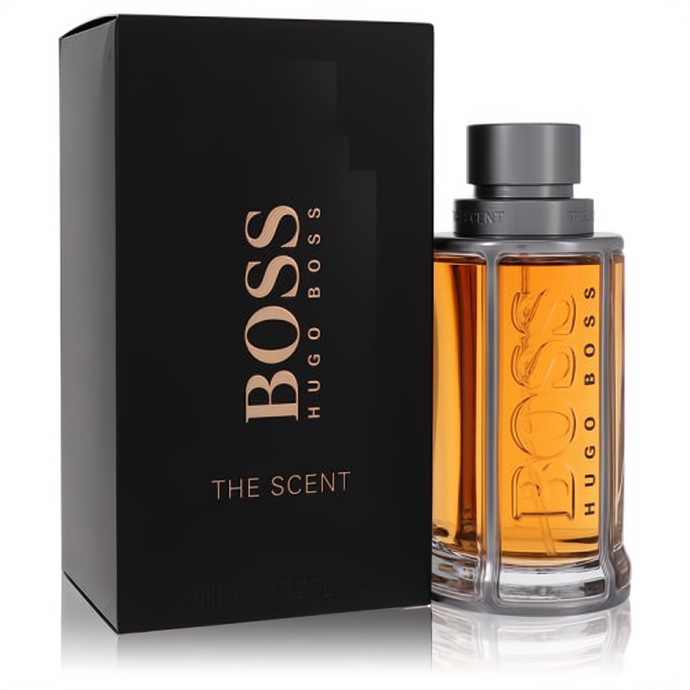 Boss The Scent 3.3 oz EDT. Amber fragrance in a unique ribbed glass bottle with a grey cap, next to its elegant black and gold box.