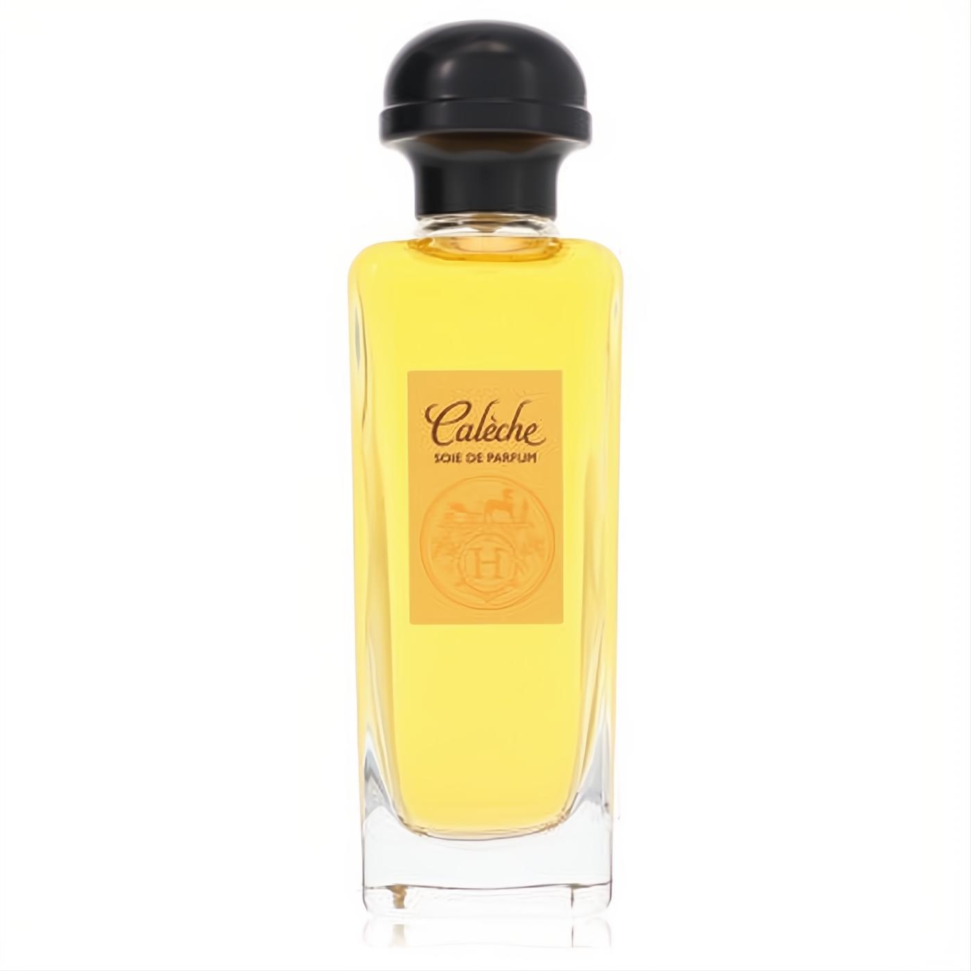 Refined Hermes Caleche Soie de Parfum for women. Clear glass bottle with radiant yellow liquid, black cap, and iconic orange label.