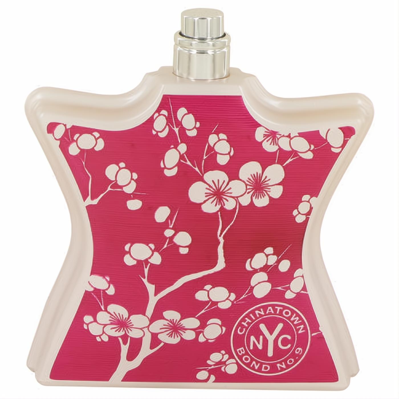 Vibrant fuchsia Bond No. 9 Chinatown perfume bottle, adorned with white cherry blossoms and a sleek silver cap.