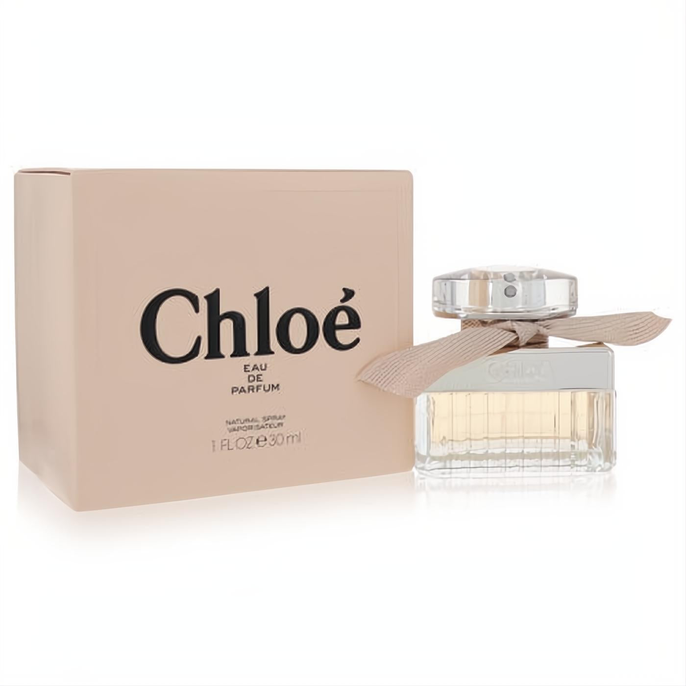 Luxurious Chloe Eau De Parfum 1 oz spray. Elegant ridged glass bottle with a silver cap and signature pink ribbon, beside its blush box.