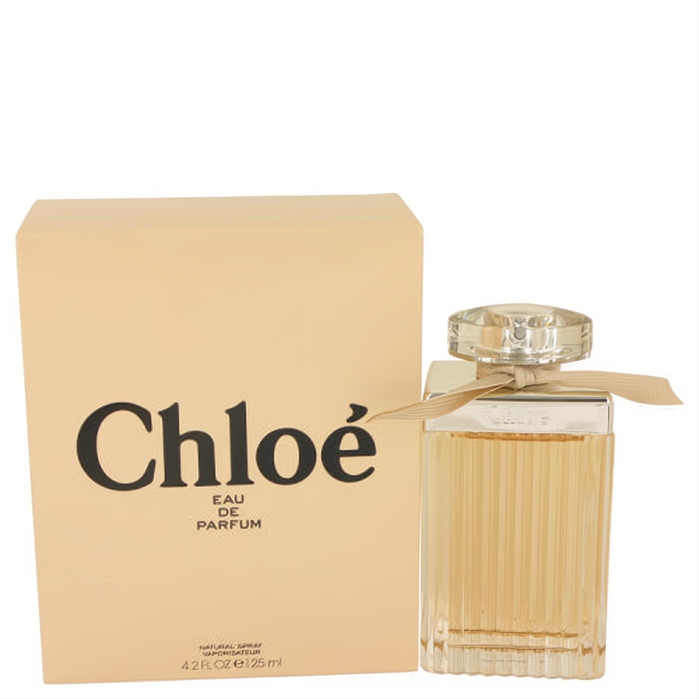 Luxurious Chloe Eau De Parfum 4.2 oz spray. Clear ribbed glass bottle, faceted cap, delicate beige ribbon, and matching box.