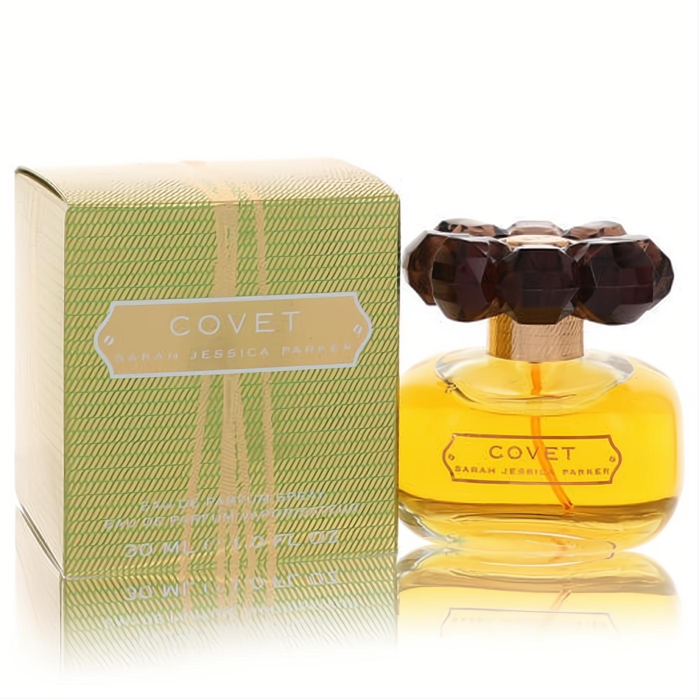 Covet by SJP 1 oz Eau De Parfum: a radiant clear bottle with golden liquid and a striking dark brown jewel-like cap, next to its elegant green box.