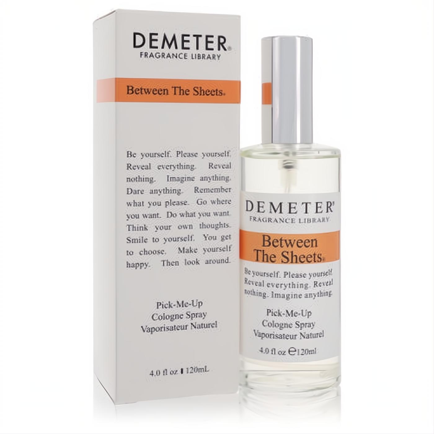 Captivating Demeter Between The Sheets 4 oz cologne spray. Clear glass bottle, silver cap, and sleek white box with bold orange accents.