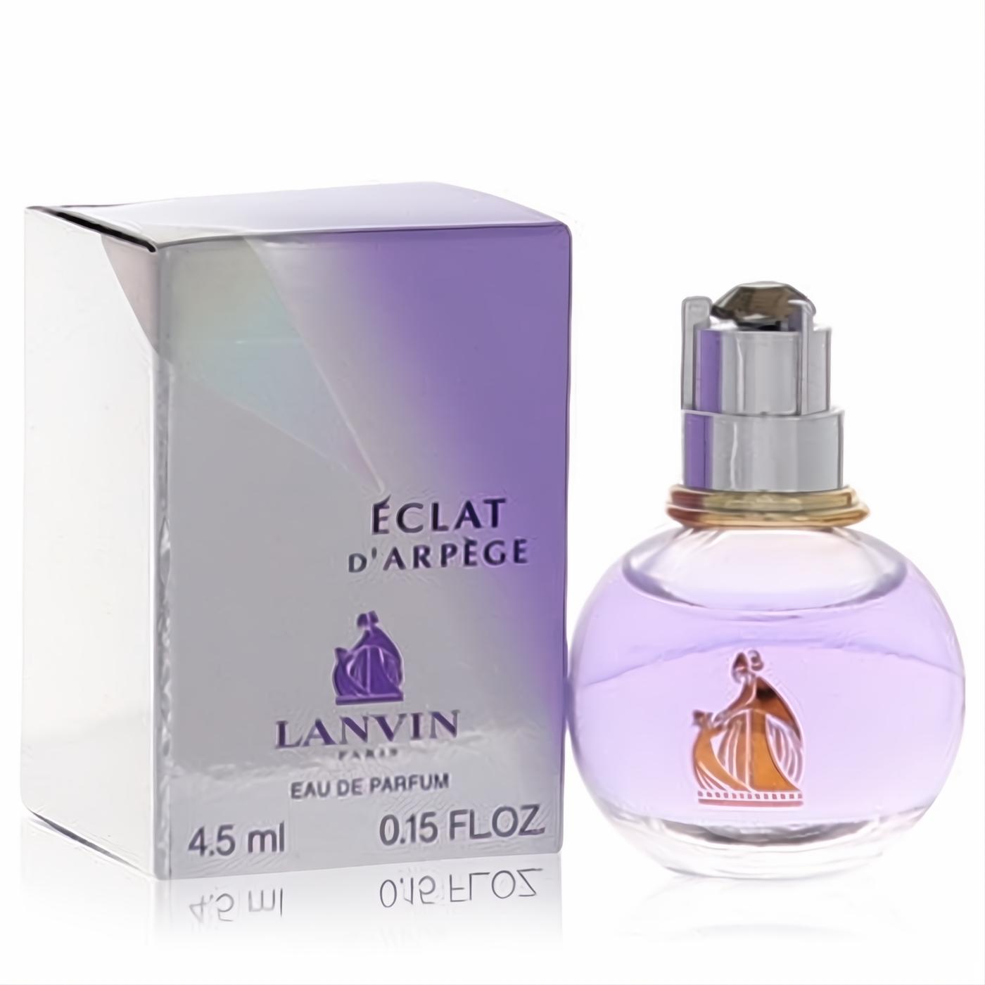 Elegant Lanvin Eclat D'Arpege mini EDP 0.15 fl oz. Round purple glass bottle with silver cap and iridescent box.