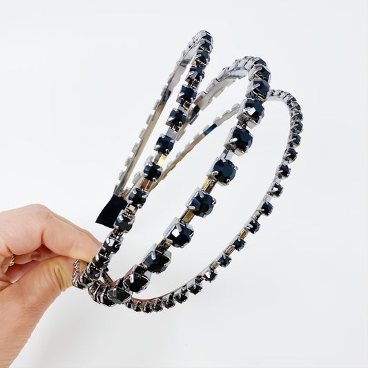 Sparkling Ensemble Of Shine headband featuring three rows of brilliant black rhinestones on a sleek silver band.