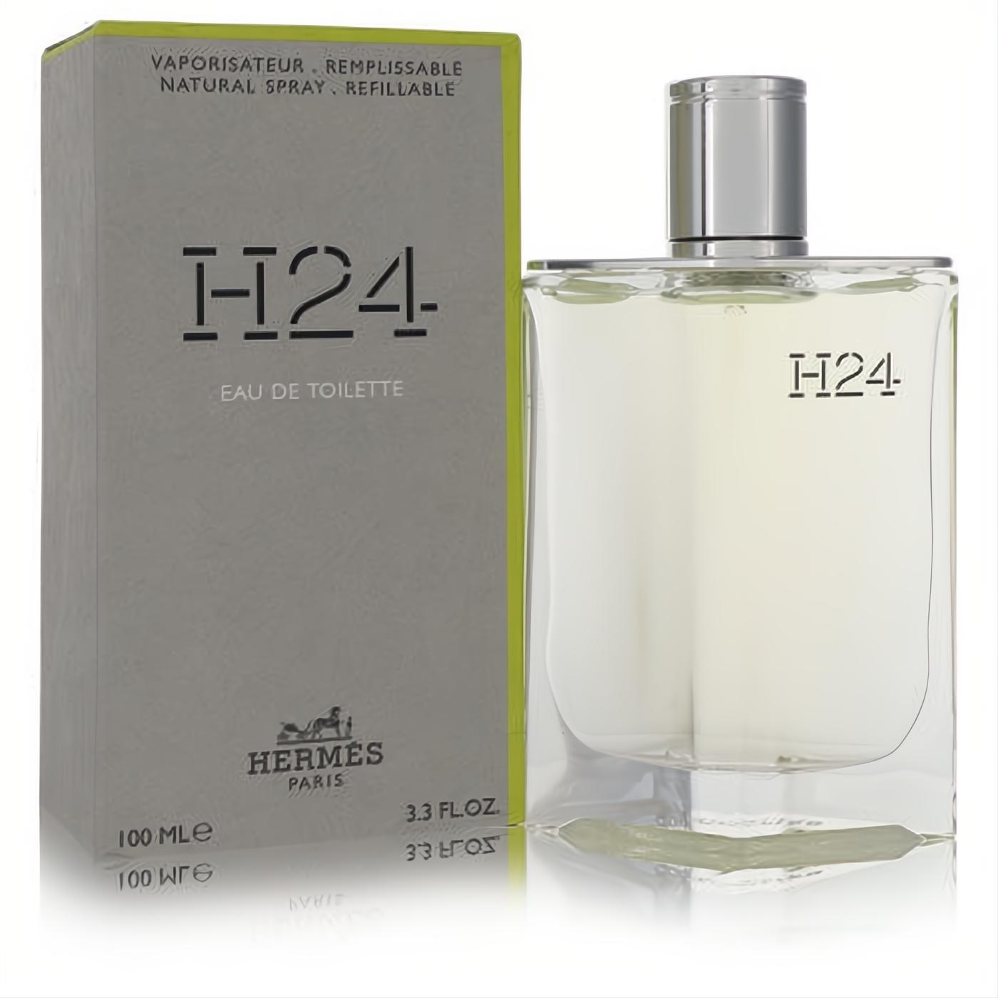 Experience Hermes H24 Eau De Toilette 3.3 oz refillable spray: a sleek clear glass bottle with silver cap, next to its modern green box.
