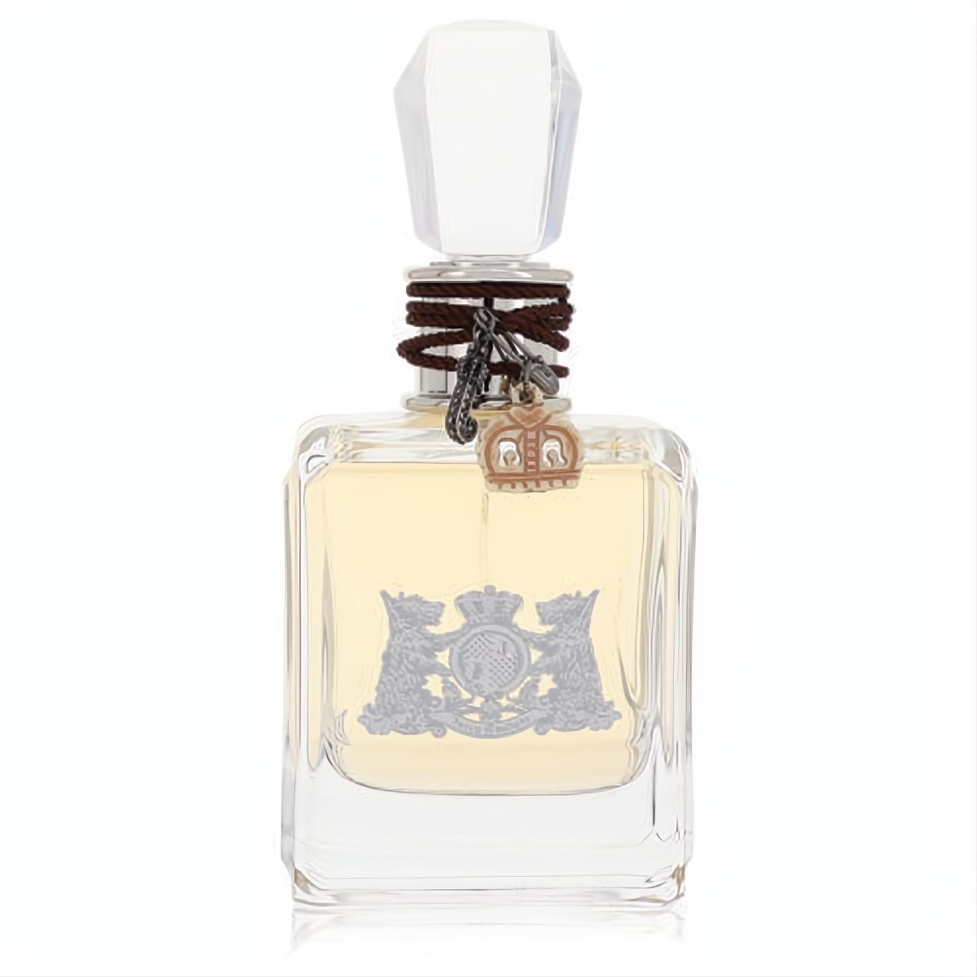 Elegant Juicy Couture perfume bottle. Clear glass, faceted cap, brown braided cord, and iconic silver crest.