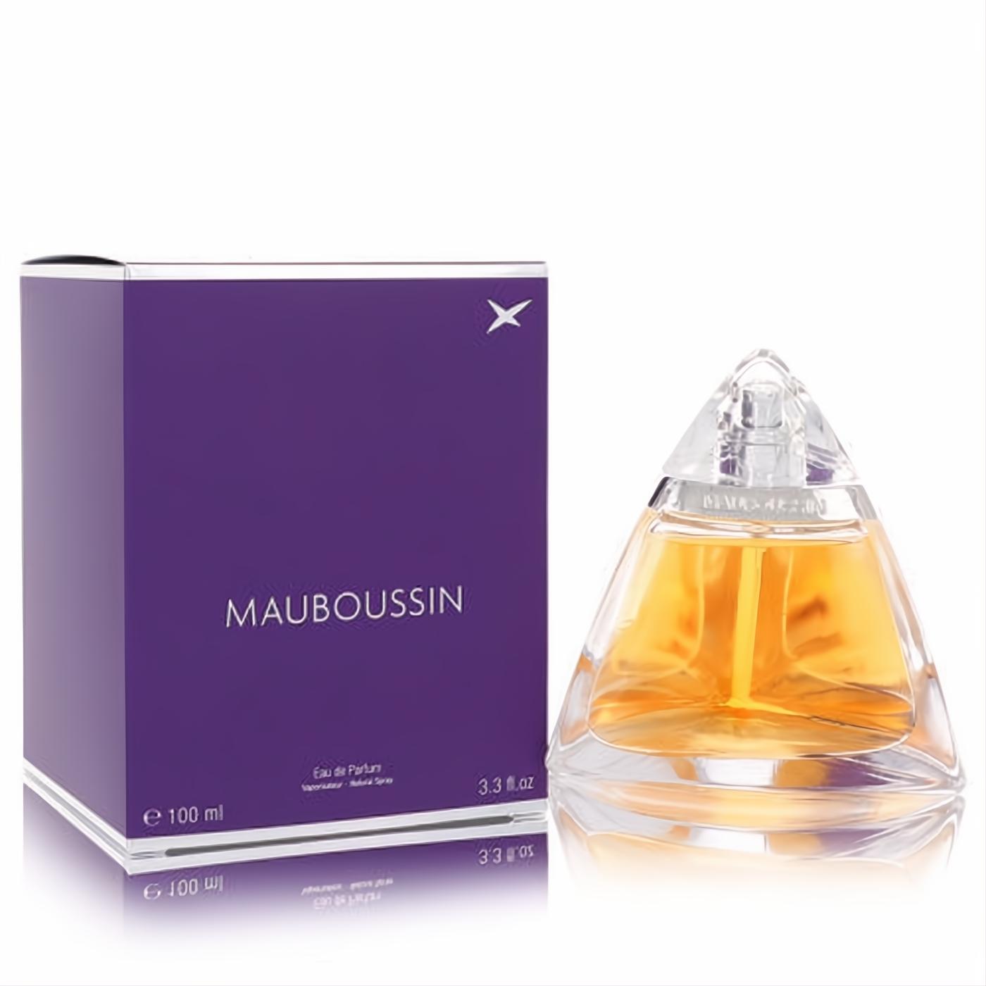 Mauboussin women's Eau De Parfum, 3.3 fl.oz. Unique clear pyramid bottle with golden liquid, beside a vibrant purple box.