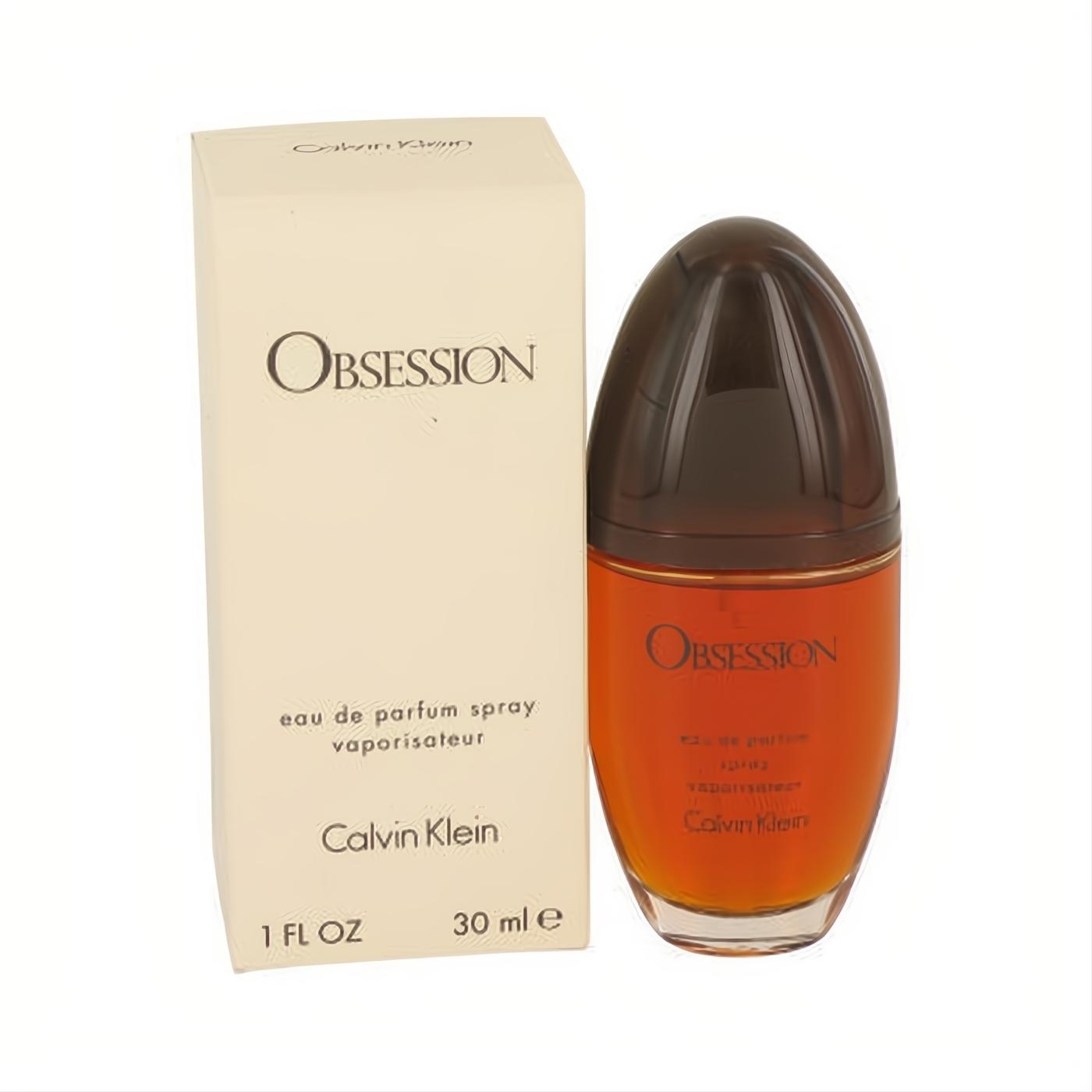 Sensual Calvin Klein Obsession 1 oz EDP spray. Warm amber liquid in an elegant oval bottle with a dark cap, beside its cream box.