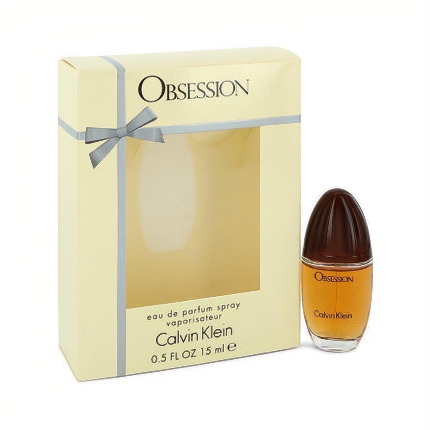 Calvin Klein Obsession 0.5 oz EDP. Distinctive amber fragrance bottle with dark cap, presented in an elegant cream box with ribbon.