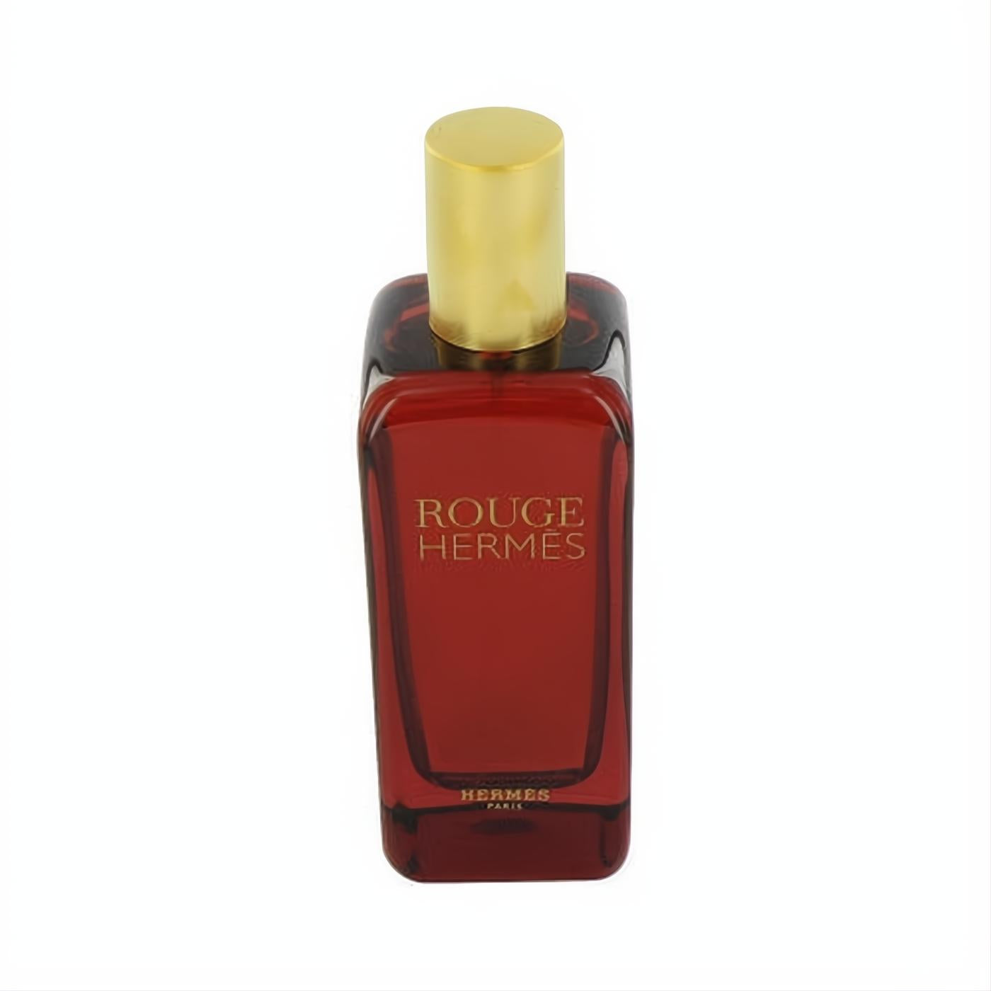 Iconic Rouge Hermes Eau De Toilette spray in a rich red glass bottle with a gleaming gold cap. Sophisticated fragrance.