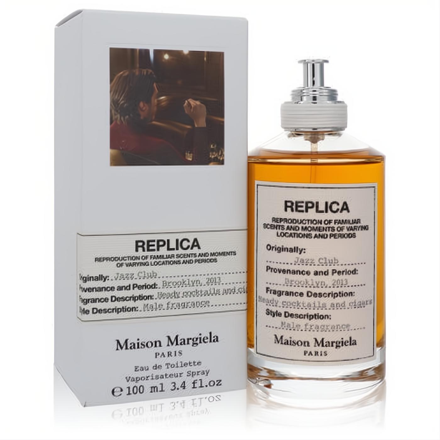 Replica Jazz Club Maison Margiela 3.4 oz EDT spray. Amber liquid in a clear bottle with a white label and silver cap, next to its white box.