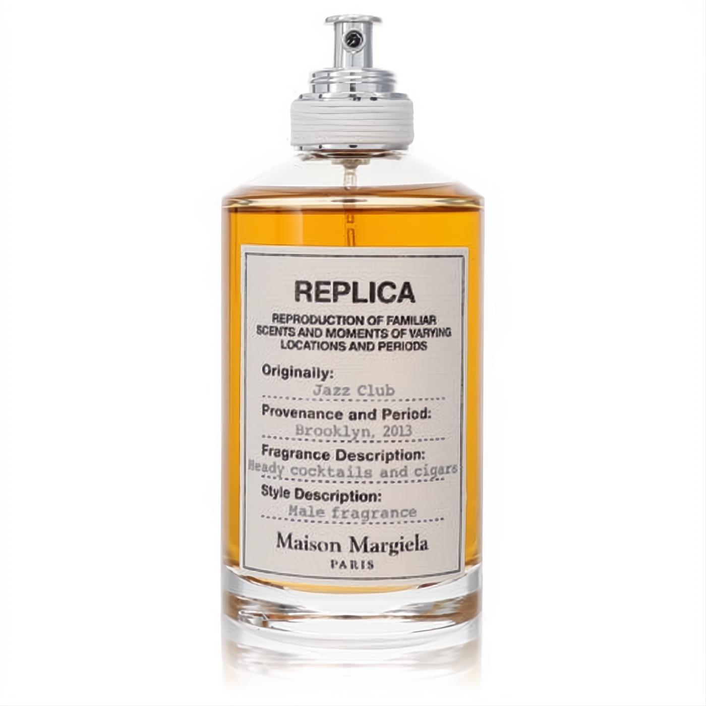Maison Margiela Replica Jazz Club EDT spray. Clear glass bottle with warm amber liquid, cream label, sleek silver sprayer.