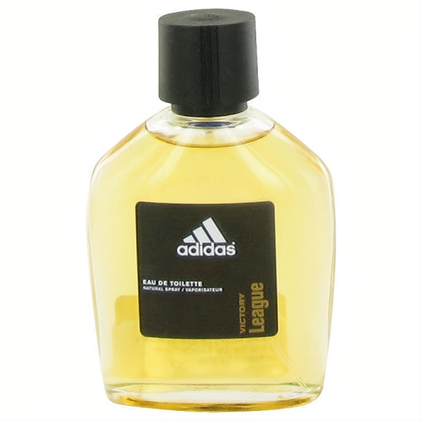 Adidas Victory League 3.4 oz men's EDT spray. Clear glass bottle, golden fragrance, sleek black cap, and iconic logo label.