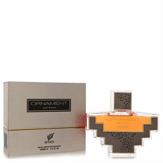 Afnan Ornament 3.4 oz women's perfume. Unique gold-accented clear geometric bottle with amber liquid, beside its textured gold box.