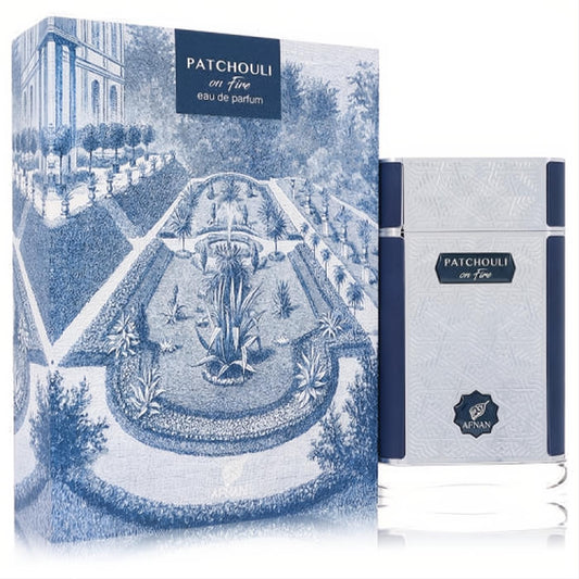 Afnan Patchouli On Fire 2.7 oz unisex EDP. Striking silver textured bottle with blue accents, beside a captivating blue garden box.