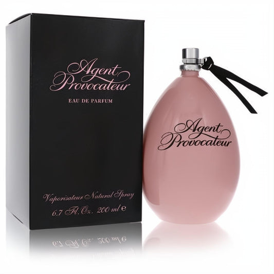 Agent Provocateur 6.7 oz women's Eau De Parfum. Elegant blush pink egg bottle, silver cap, black ribbon, and sleek black box.