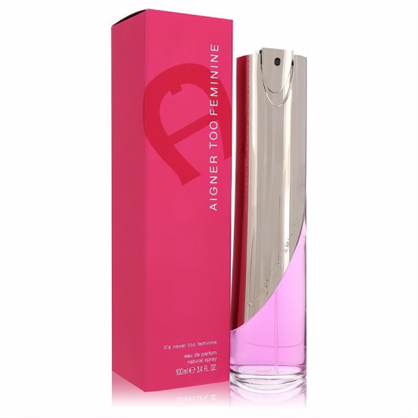 Aigner Too Feminine 3.4 oz EDP spray bottle, featuring a sleek silver top and vibrant pink liquid, next to its matching fuchsia box.