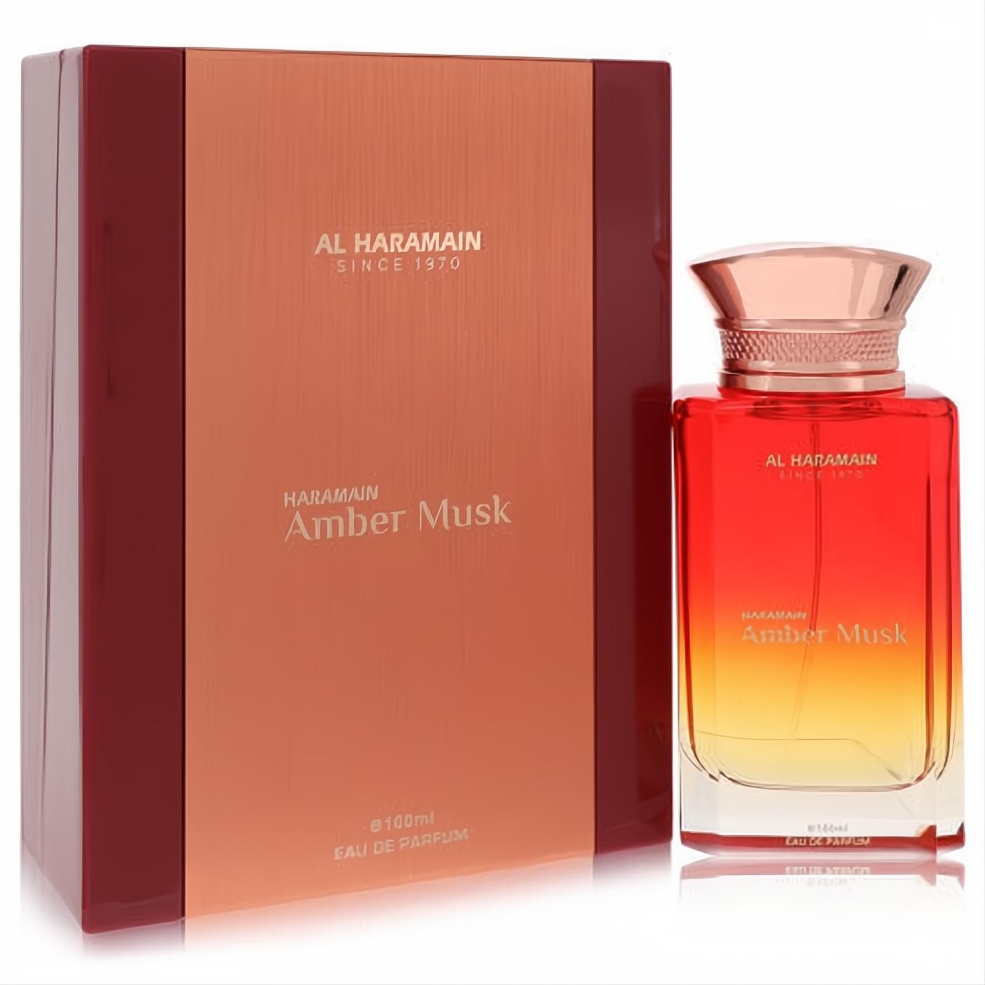 Al Haramain Amber Musk 3.3 oz unisex EDP in a stunning red-orange gradient glass bottle with a rose gold cap, next to its elegant box.