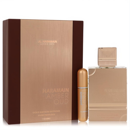 Luxurious Al Haramain Amber Oud Gold Extreme gift set. Features a 3.4 oz gold geometric bottle, 0.34 oz refillable spray, and elegant brown box.