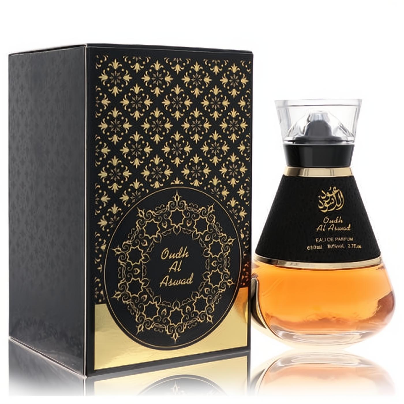 Al Wataniah Oudh Al Aswad unisex EDP, 3.4 fl.oz. Features a striking black and gold bottle with amber liquid, displayed next to its ornate matching box.