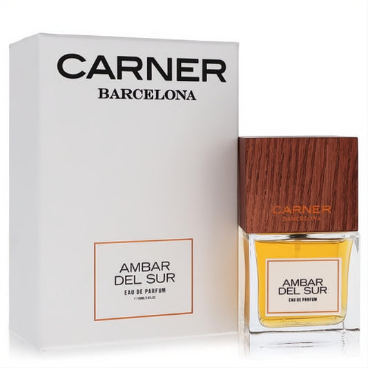 Luxurious Carner Barcelona Ambar Del Sur unisex EDP. Amber fragrance in a clear bottle with a distinctive wood cap, beside its elegant white box.