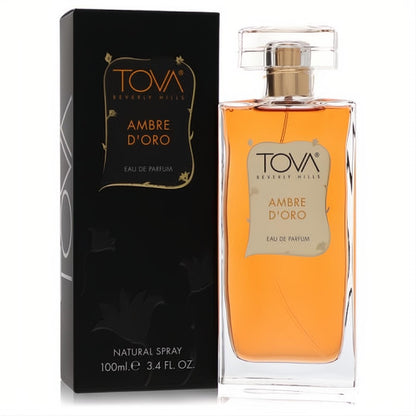 Luxurious Tova Beverly Hills Ambre D'Oro 3.4 oz EDP. Clear bottle with radiant amber liquid, beside its sleek black and gold box.