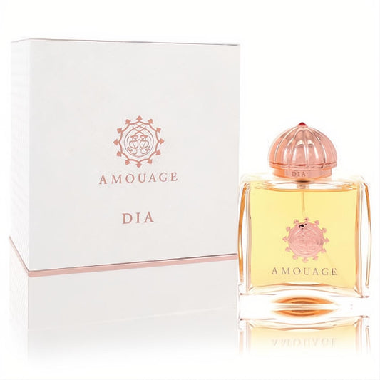 Amouage Dia 3.4 oz EDP for women. Golden liquid in a clear bottle with a rose gold ribbed cap, next to its elegant white box.