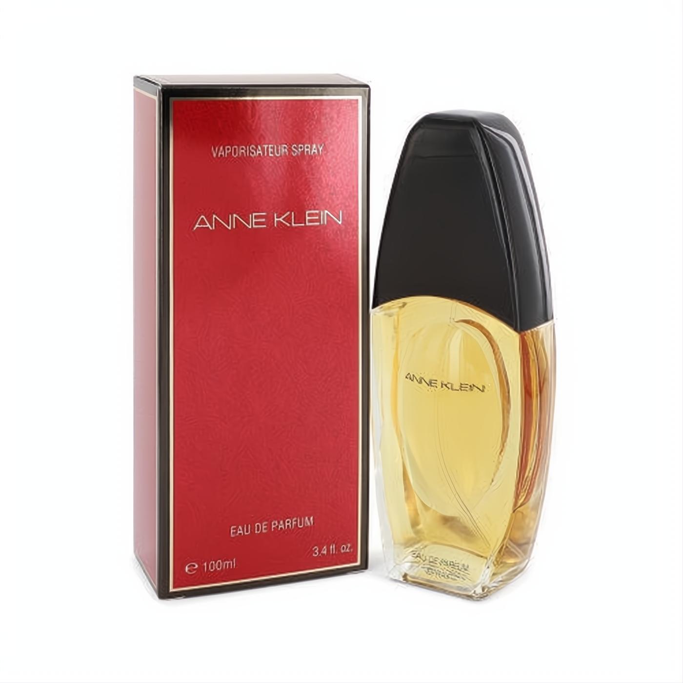 Anne Klein Eau De Parfum 3.3 oz spray. Elegant clear glass bottle with golden liquid and sleek black cap, beside its classic red box.