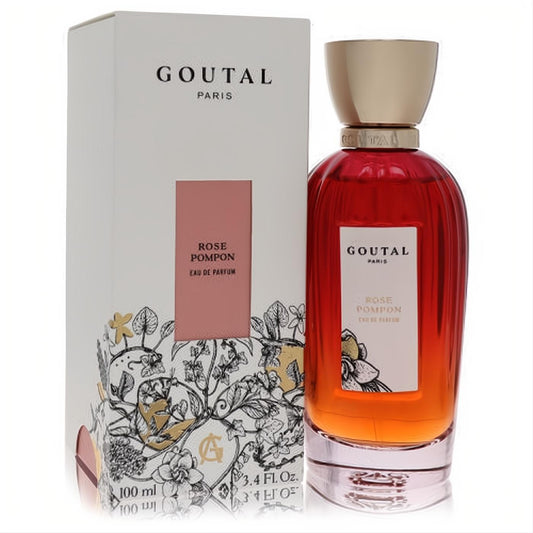Annick Goutal Rose Pompon 3.4 oz EDP spray. Elegant clear bottle with vibrant reddish-orange perfume, gold cap, and decorative white floral box.