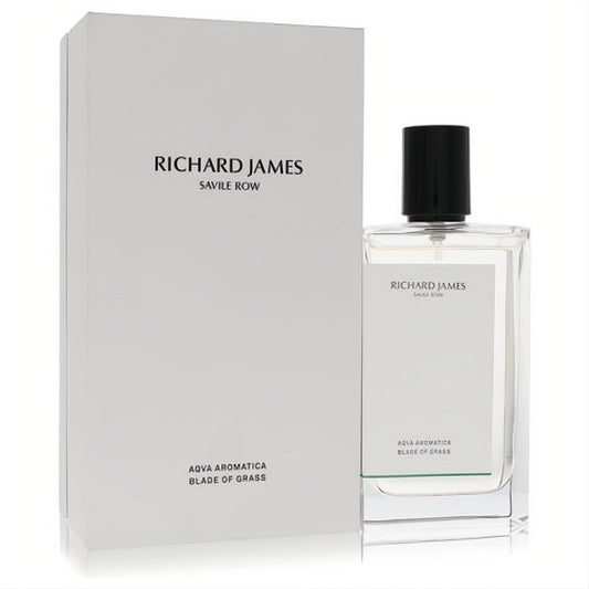 Richard James Aqua Aromatica Blade of Grass cologne. Elegant clear glass bottle with black cap and subtle green detail, beside its white box.