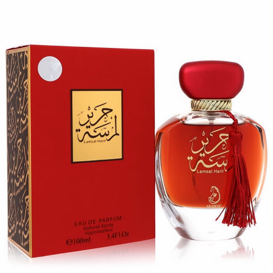 Exquisite Arabiyat Lamsat Harir 3.4 oz EDP. Luxurious red and gold bottle with tassel, matching box, and elegant Arabic script.