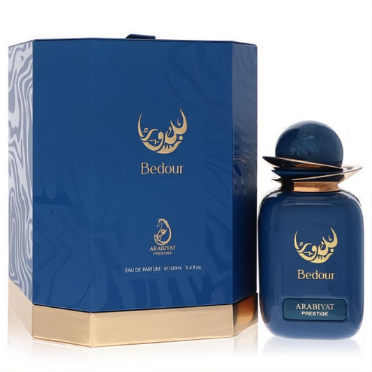Arabiyat Prestige Bedour 3.4 oz unisex Eau De Parfum. Luxurious dark blue bottle with gold details and elegant hexagonal packaging.