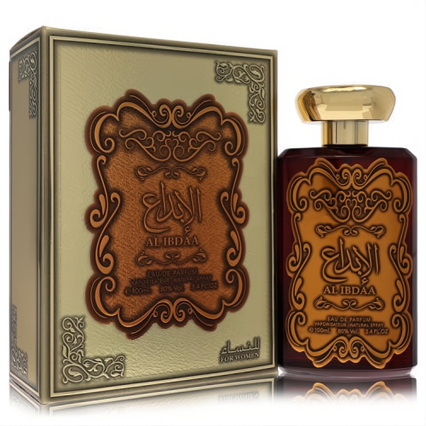 Ard Al Zaafaran Al Ibdaa 3.4 oz women's EDP bottle, rich amber glass with gold ornate label and cap, next to its matching gold embossed box.