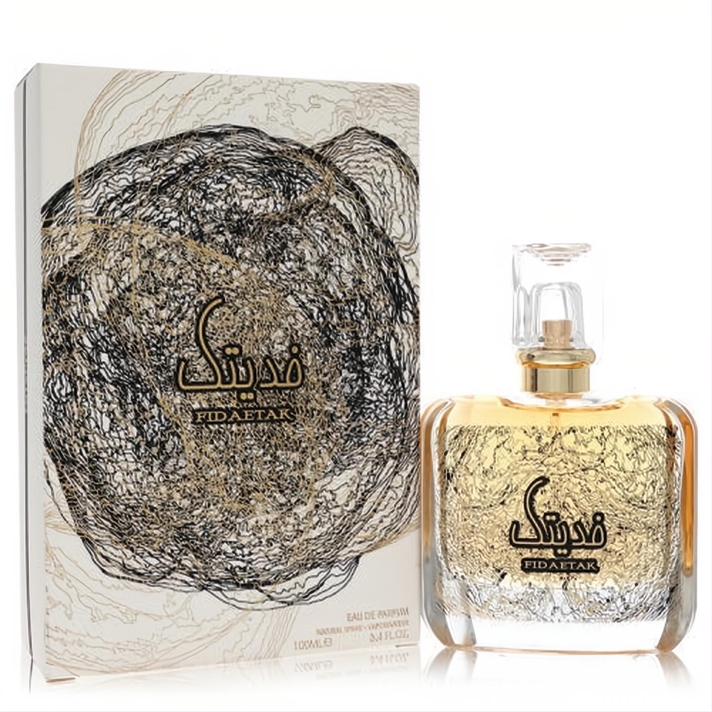 Ard Al Zaafaran Fidaetak unisex EDP 3.4 oz. Clear bottle with golden liquid, captivating black and gold swirl design, and matching box.