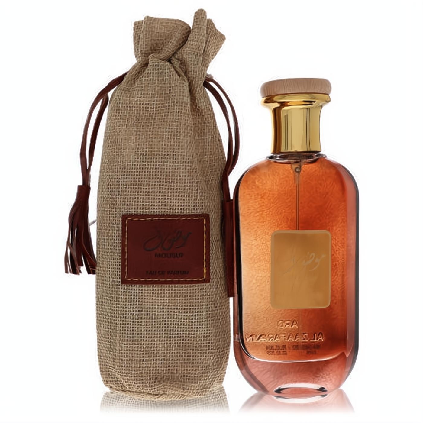 Ard Al Zaafaran Mousuf 3.4 oz unisex perfume. Amber liquid in a clear bottle with gold cap, paired with a rustic burlap pouch.