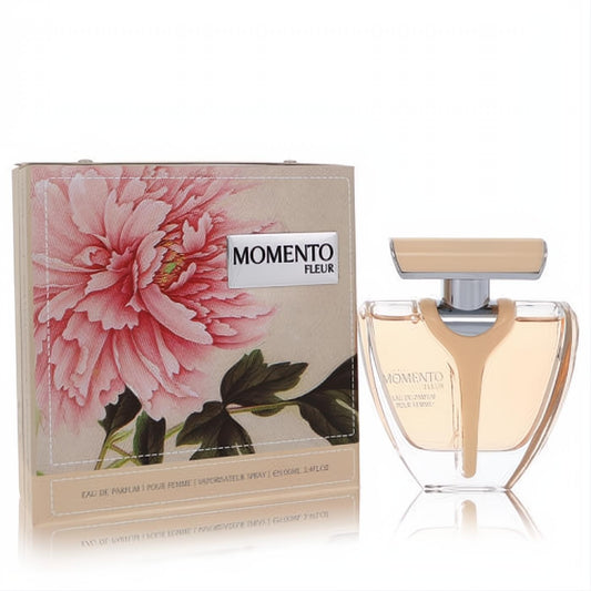 Elegant Armaf Momento Fleur 3.4 oz EDP spray. Clear V-shaped bottle with amber liquid, gold cap, and a beautiful pink peony box.