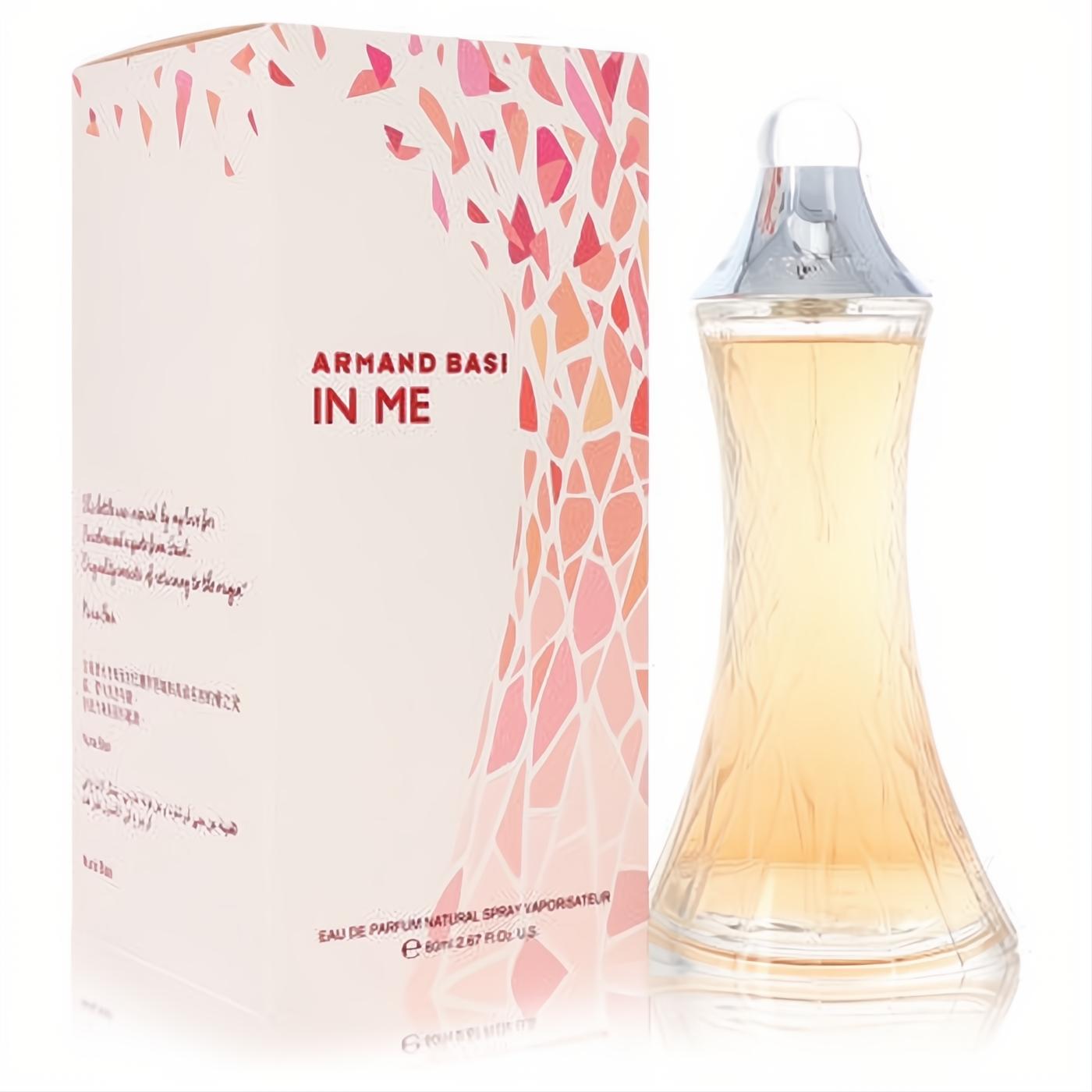 Armand Basi In Me 2.6 oz EDP spray. Elegant clear glass bottle with amber liquid, silver cap, and a white box with pink floral design.