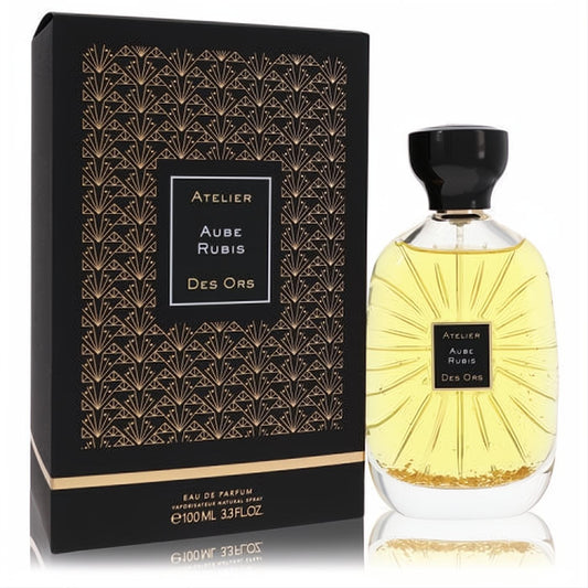 Luxurious Aube Rubis Des Ors 3.3 oz unisex Eau De Parfum. Golden liquid in clear bottle with black cap and elegant art deco box.