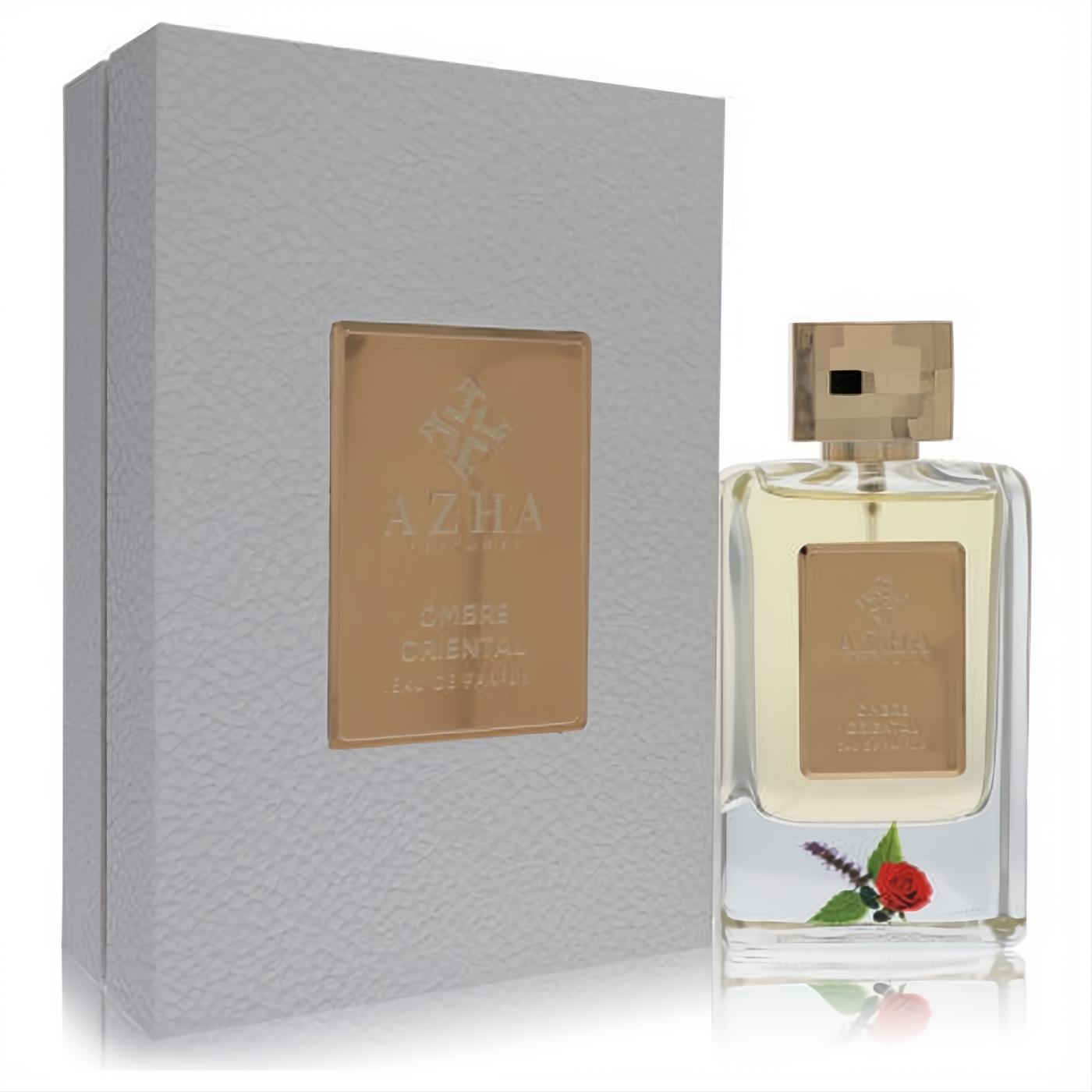 Experience Azha Ombre Oriental 3.33 oz EDP. Elegant clear bottle, gold geometric cap, delicate rose & lavender, and a luxurious grey box.