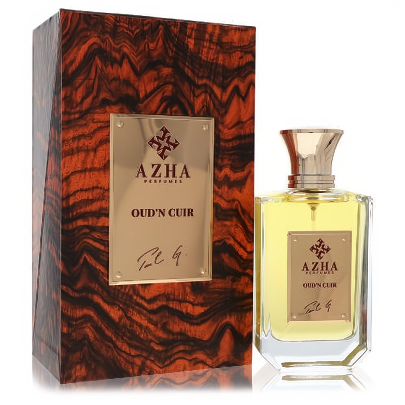 Luxurious Azha Oud'n Cuir EDP. Elegant clear glass bottle with golden liquid, ornate gold cap, and a rich dark wood grain presentation box.