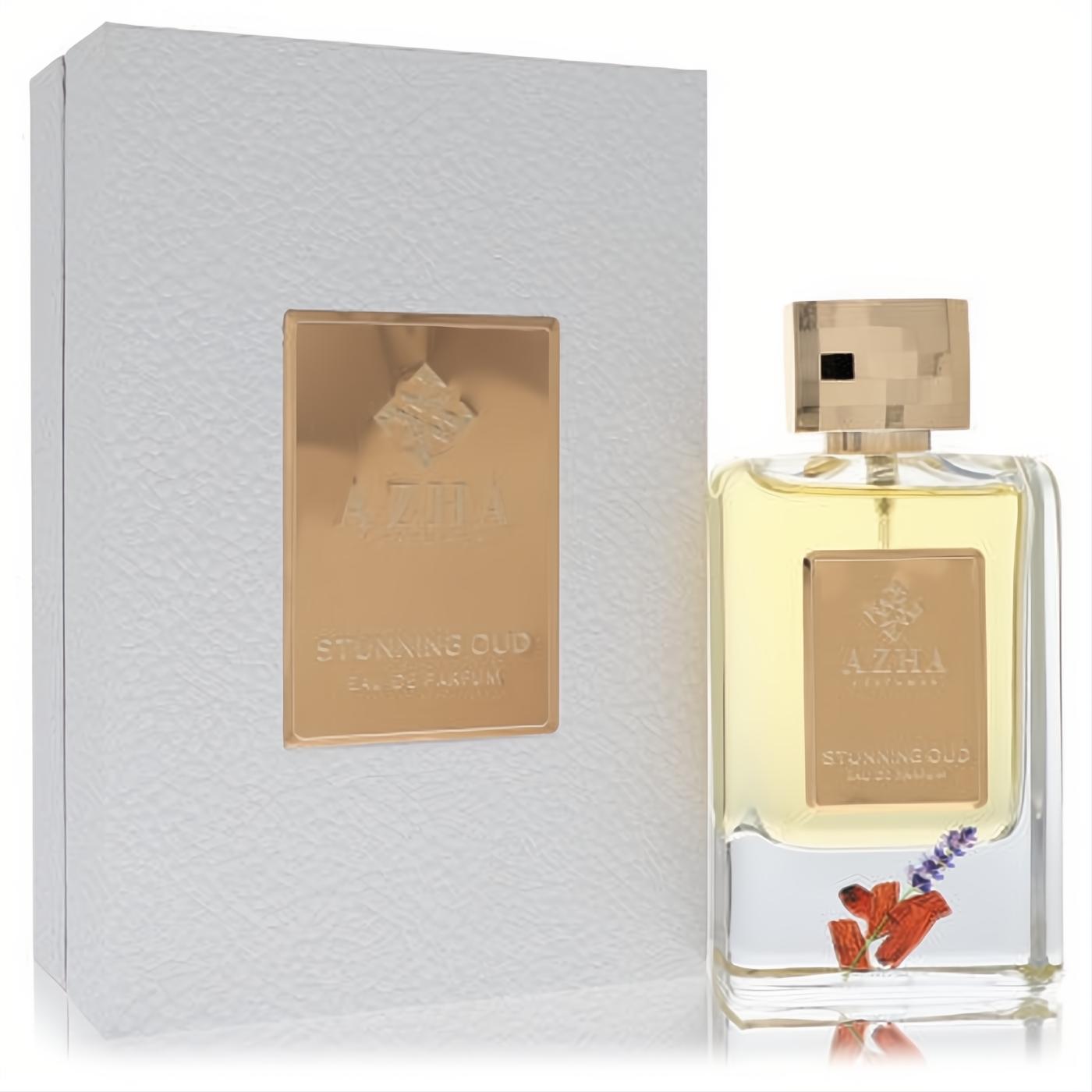 Elevate your scent with Azha Stunning Oud Eau De Parfum. Clear glass bottle, gold accents, and real lavender inside a white textured box.