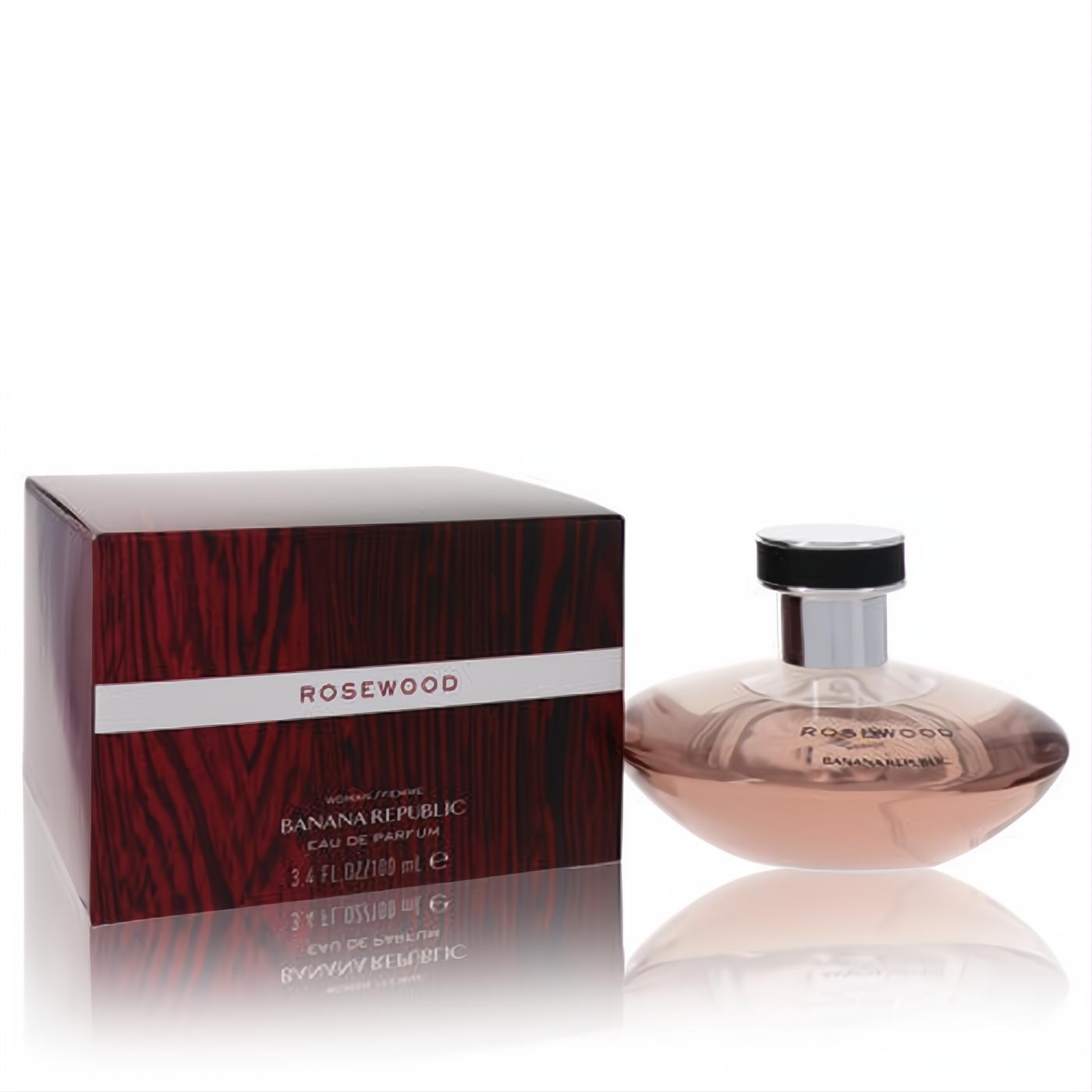Banana Republic Rosewood 3.4 oz Eau de Parfum. Chic oval bottle with blush pink fragrance next to a luxurious rosewood-patterned box.